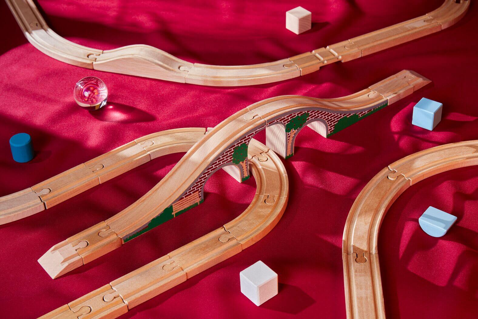 Wooden train set pieces arranged and connected with various pieces